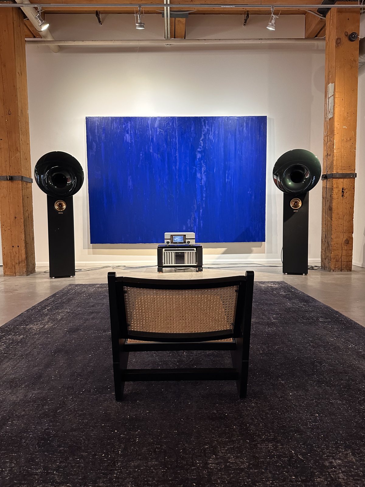 Acapella Room — horns flanking the Klein blue painting, listening chair on the rug